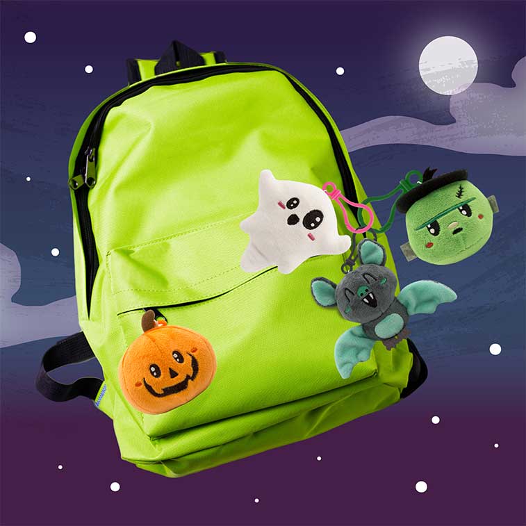 Bundle of 4 Spooky Squad Backpack Buddies, Scented Plush clipped onto a green backpack with a moon and dark sky background