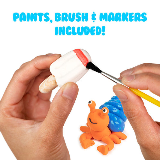 White Air Dough popsicle being painted red with a brush and one Air Dough character nearby watching